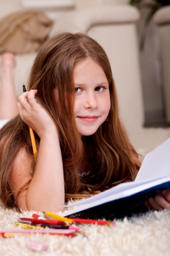 A Girl Doing Homework by photostock